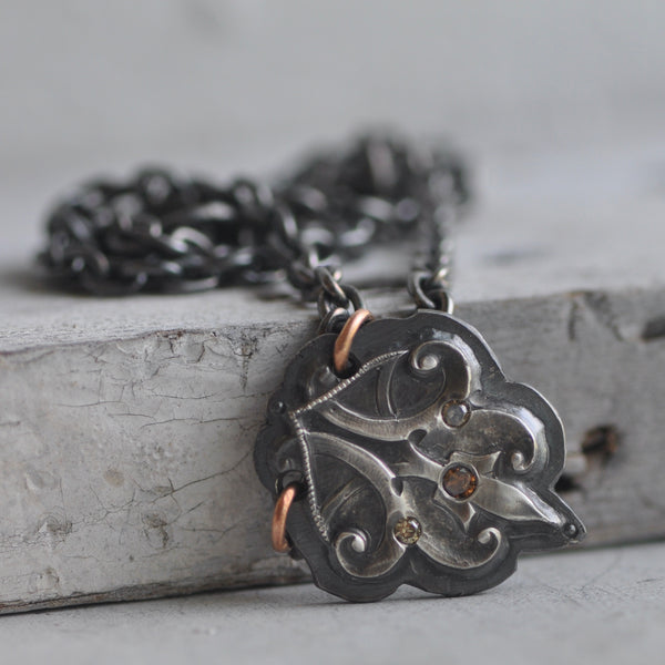 forged sterling pendant with flush set diamonds